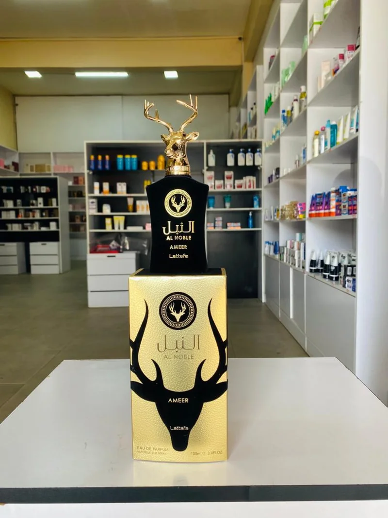 Black bottle with a gold deer-shaped cap and matching gold-and-black box — Lattafa Al Noble Ameer