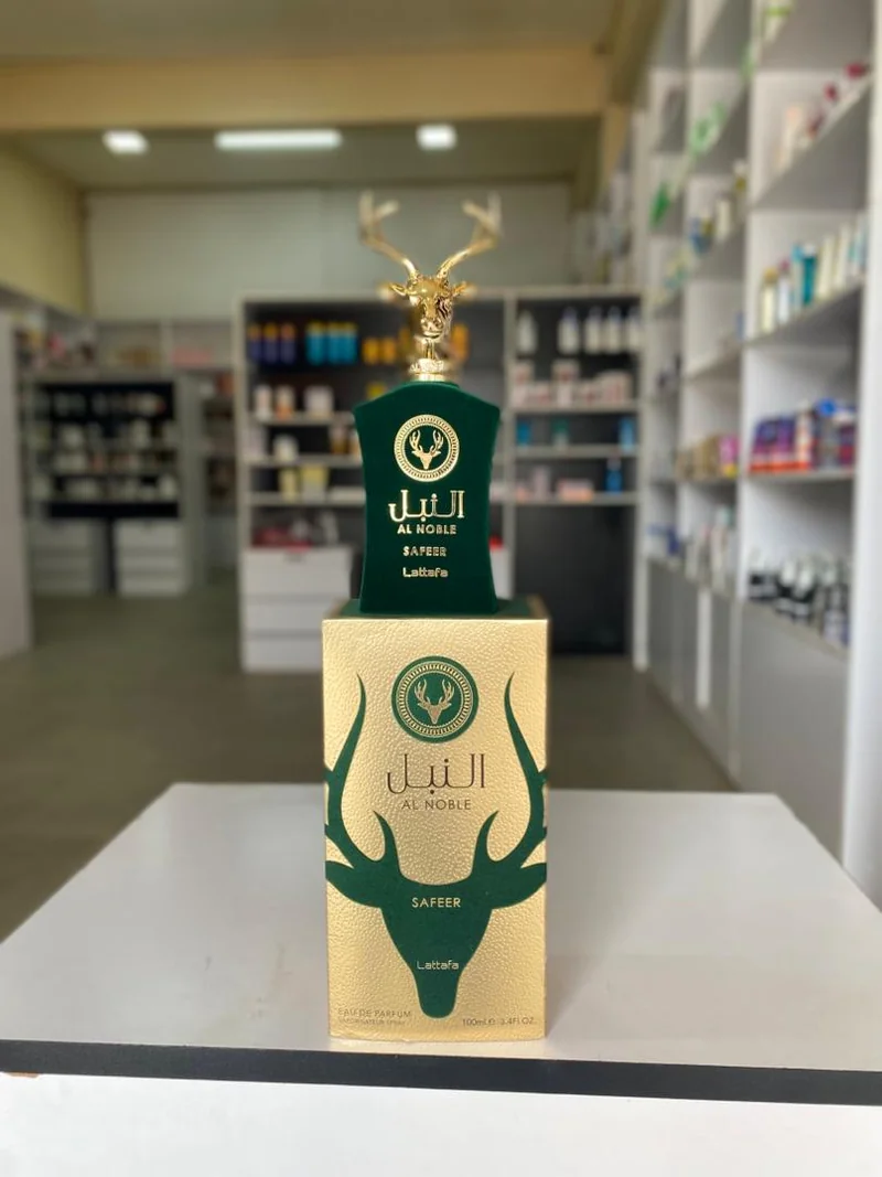 Green bottle with a gold deer-shaped cap and matching green-and-gold box — Lattafa Al Noble Safeer