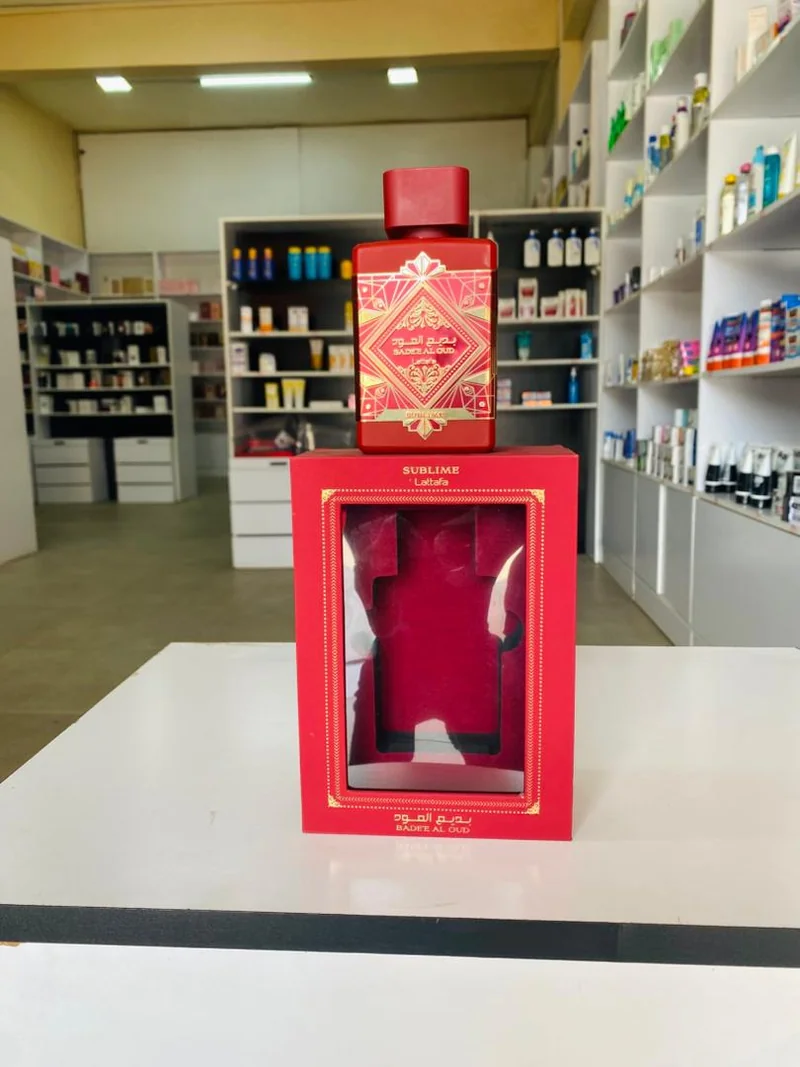Red rectangular bottle with gold-patterned label and matching red box — Lattafa Bade’e Al Oud Sublime
