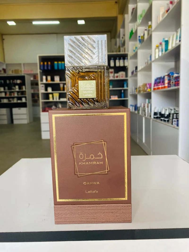 Faceted clear bottle with amber liquid and a brown Qahwa box — Lattafa Khamrah Qahwa
